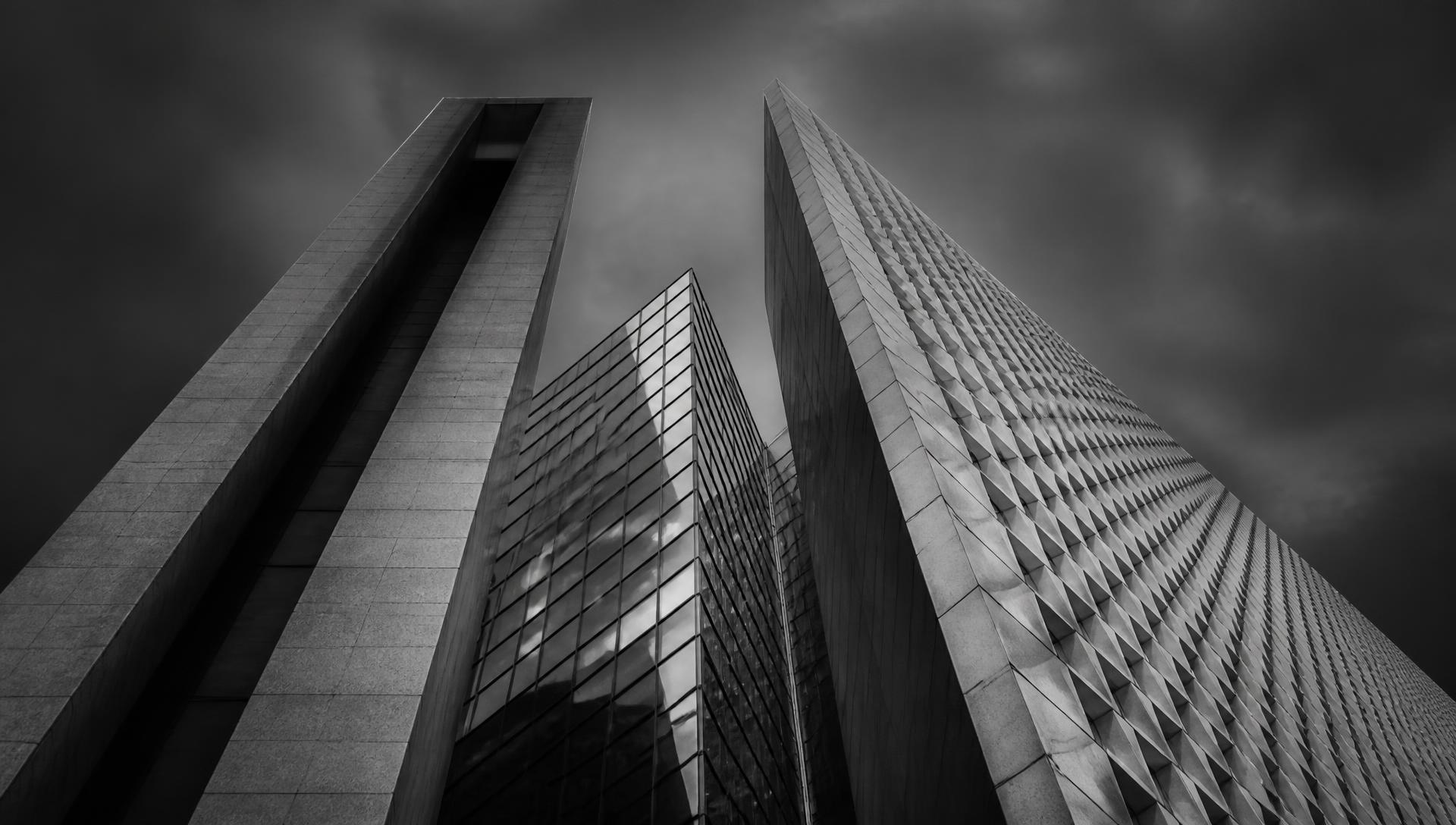 Torres corporativas fotografadas em contra-plongée, em preto e branco